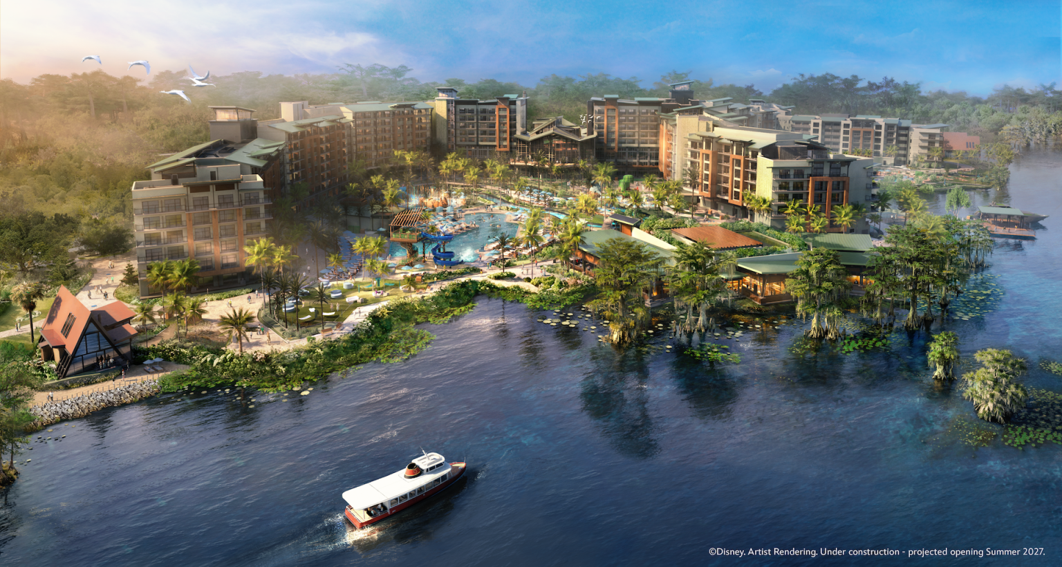 2026-DSE-Lakeshore-Lodge-Rendering-1536x820 - Vacation Club Life A large tropical resort under construction on a waterfront island, with multiple buildings surrounding a central pool and palm trees, a boat gliding on blue water in the foreground, and a forest backdrop.